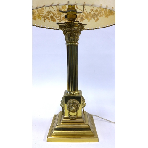 340 - Brass Corinthian column table lamp with lion mask heads, complete with shade