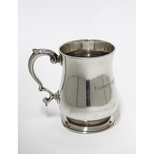 54 - Tiffany & Co, Sterling silver Christening beaker of plain baluster form with a leaf capped handle, t... 