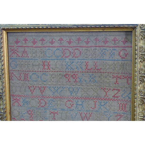 380 - Alphabet and house needlework sampler, framed under glass 22 x 43cm