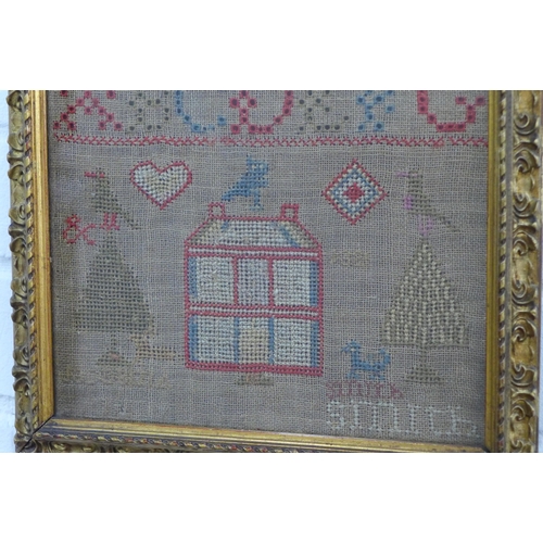 380 - Alphabet and house needlework sampler, framed under glass 22 x 43cm