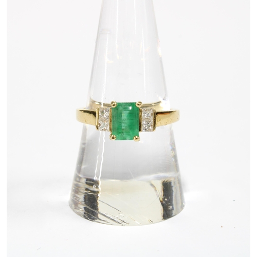 1 - 18ct gold emerald and diamond ring, the central emerald is in a four claw setting and flanked by two... 