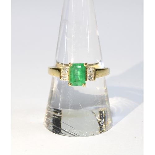 1 - 18ct gold emerald and diamond ring, the central emerald is in a four claw setting and flanked by two... 