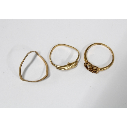 10 - 9ct gold wishbone ring, 18ct gold scrap metal ring and a dolphin ring with rubbed marks (3)