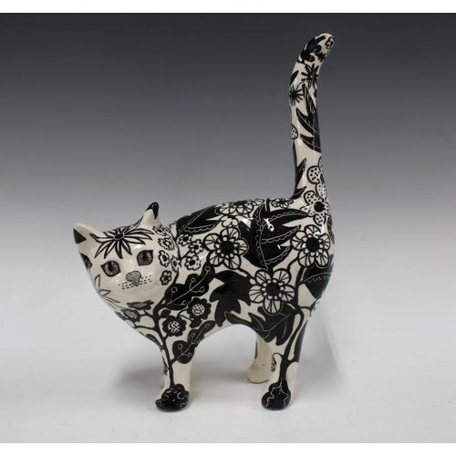 101 - Black and white pottery cat with floral painted pattern, 26 x 36cm.