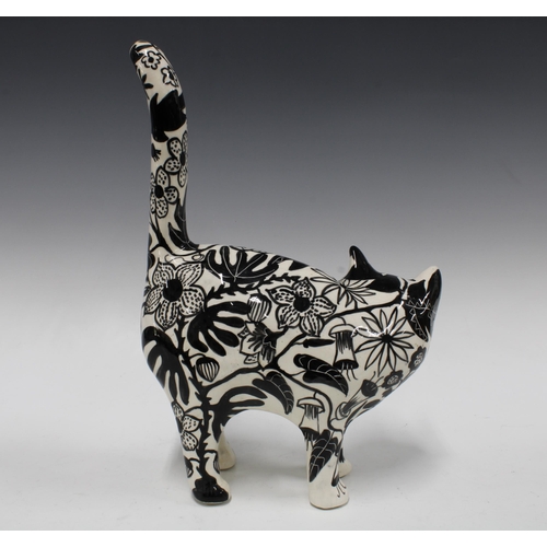 101 - Black and white pottery cat with floral painted pattern, 26 x 36cm.