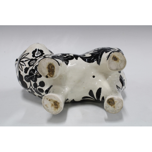 101 - Black and white pottery cat with floral painted pattern, 26 x 36cm.