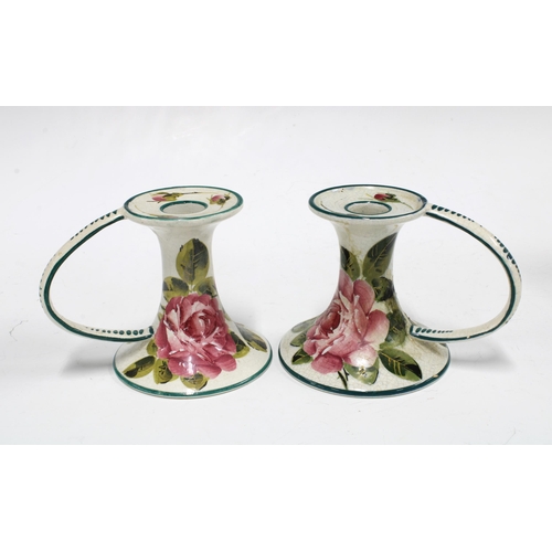 111 - Wemyss ware handpainted cabbage rose pottery to include a pair of chamber candlesticks and small tea... 