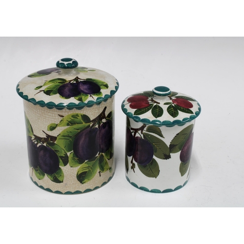 119 - Two Wemyss Ware preserve jars with covers, handpainted plums pattern, with painted marks, the larger... 