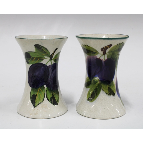 120 - Wemyss ware, a pair of handpainted plums pattern vases of waisted form, painted marks (2) 8 x 11cm.