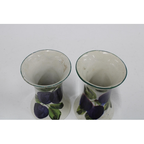 120 - Wemyss ware, a pair of handpainted plums pattern vases of waisted form, painted marks (2) 8 x 11cm.