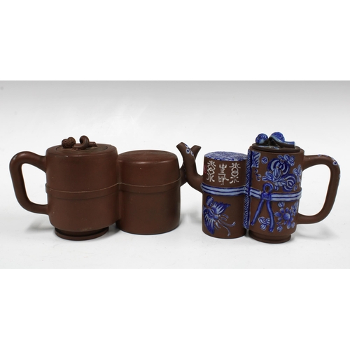 135 - Two Yixing stoneware conjoined teapots, one set with blue and overglaze pattern (2) 22cm wide.