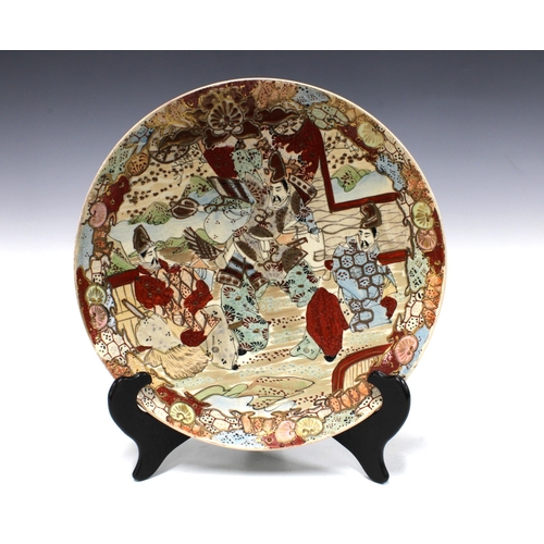 137 - Japanese earthenware charger painted with figures, 28cm.