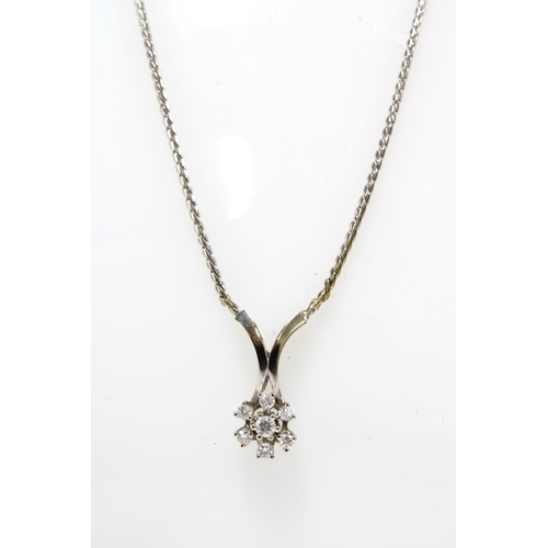 14 - 14ct white gold and diamond pendant necklace with seven diamonds in a flowerhead setting, stamped 58... 