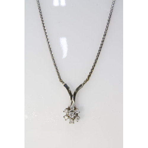 14 - 14ct white gold and diamond pendant necklace with seven diamonds in a flowerhead setting, stamped 58... 