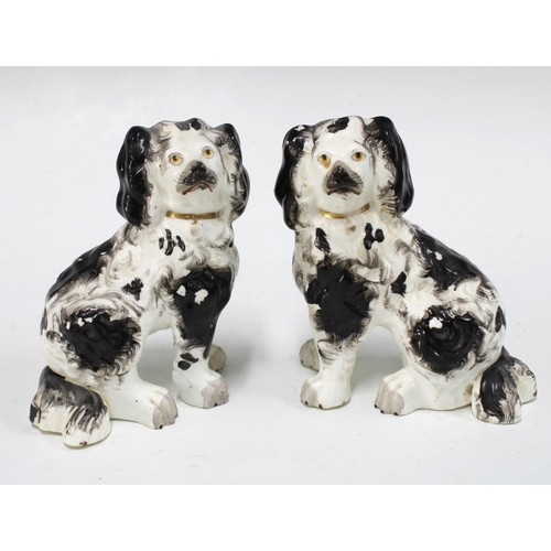 140 - A pair of black and white chimney spaniels with gilt collars and painted eyes, (2) 11 x 14cm.