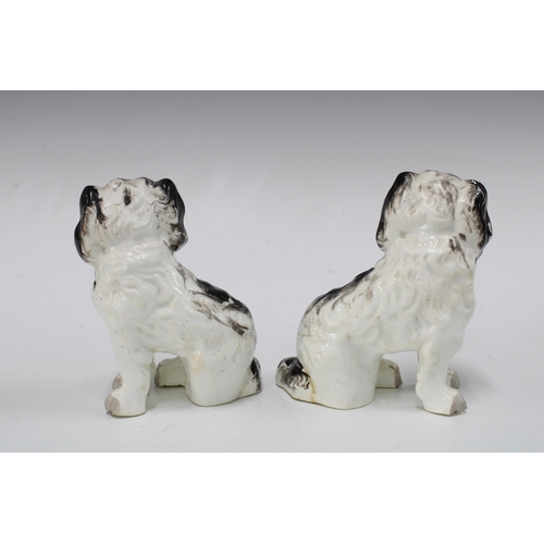 140 - A pair of black and white chimney spaniels with gilt collars and painted eyes, (2) 11 x 14cm.