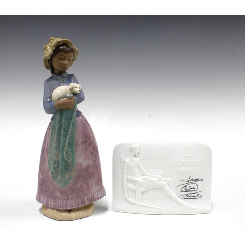 152 - Nao gres figure of a girl with her puppy and a LLadro white bisque display sign (2) 27cm.