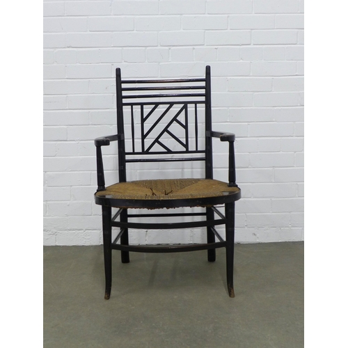 209 - An Aesthetic Movement ebonised open armchair, after E.W Godwin, Cockpen back and woven rush seat, 54... 