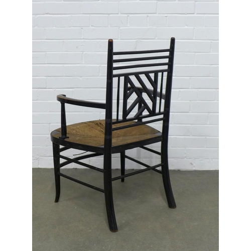 209 - An Aesthetic Movement ebonised open armchair, after E.W Godwin, Cockpen back and woven rush seat, 54... 