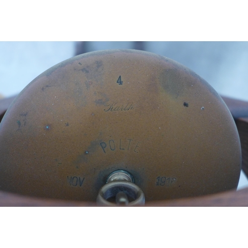 213 - WWI brass shell case dinner gong in an oak stand, 35 x 109cm.