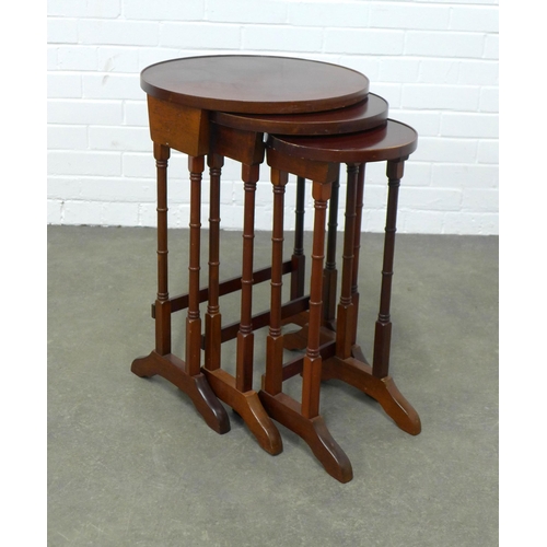 214 - Mahogany nest of three tables, circular tops on twin turned legs, 64 x 43cm.