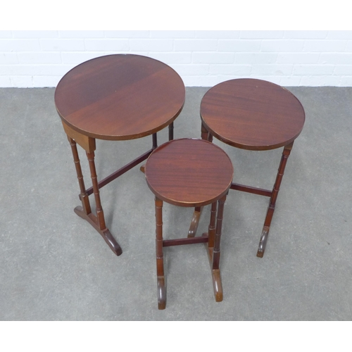 214 - Mahogany nest of three tables, circular tops on twin turned legs, 64 x 43cm.