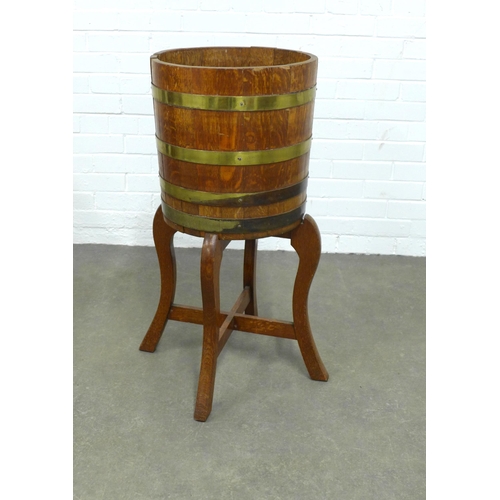 223 - An oak and brass mounted barrel on stand, 40 x 86cm.