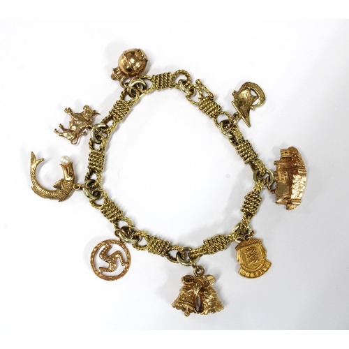 24 - 9ct gold charm bracelet with rose twist links hung with  eight various 9ct gold charms