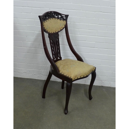 252 - Set of three art nouveau mahogany  side chairs, with stylised pierced top rial and fruit carved spla... 