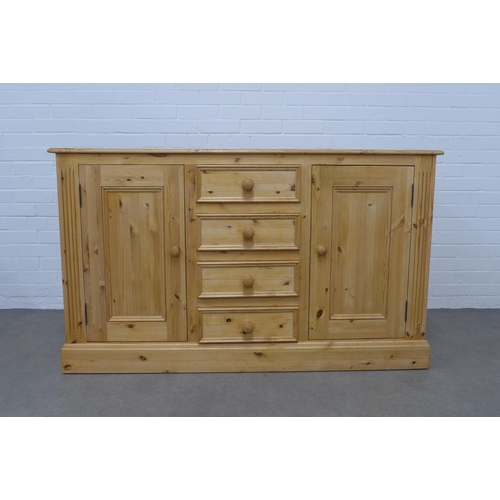 256 - Pine low dresser, the rectangular top above four short central drawers, flanked by cupboard doors an... 