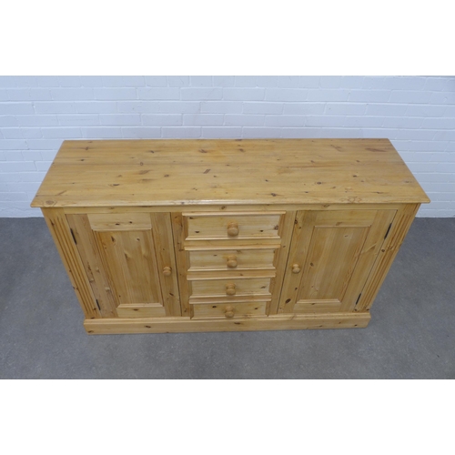 256 - Pine low dresser, the rectangular top above four short central drawers, flanked by cupboard doors an... 