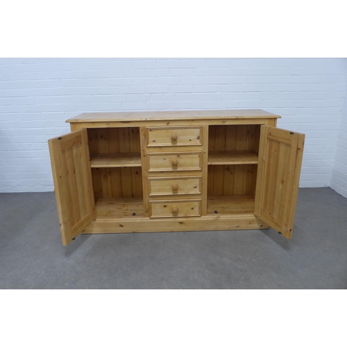 256 - Pine low dresser, the rectangular top above four short central drawers, flanked by cupboard doors an... 