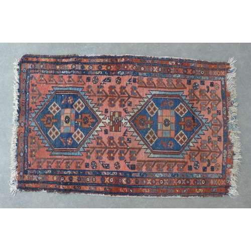 274 - Persian rug, rose field with two hexagonal medallions,  128 x 79cm.