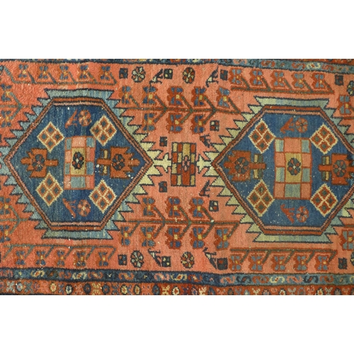 274 - Persian rug, rose field with two hexagonal medallions,  128 x 79cm.