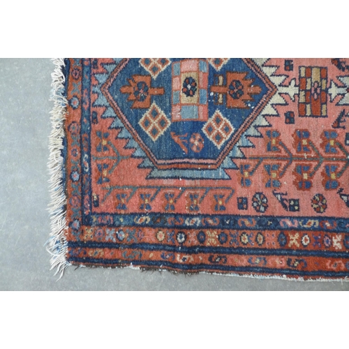 274 - Persian rug, rose field with two hexagonal medallions,  128 x 79cm.