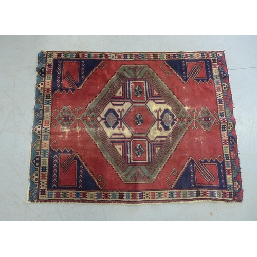 275 - Turkish rug, red field with blue spandrels and central medallion with hooked border, 150 x 114cm.