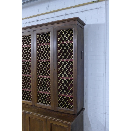 286 - Large 19th century stained pine bookcase cabinet,  the three cupboard doors with brass grills enclos... 