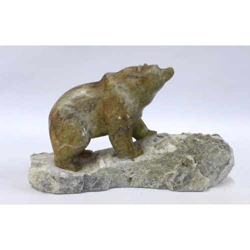 311 - A carved stone grizzly bear,  on a rocky base with name plaque 'Fran' 36cm.