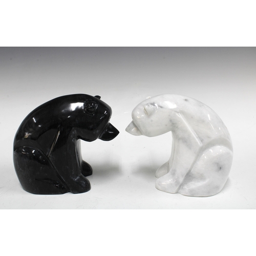 328 - A polished black stone polar bear and another in white veined stone (2) 18 x 16cm.