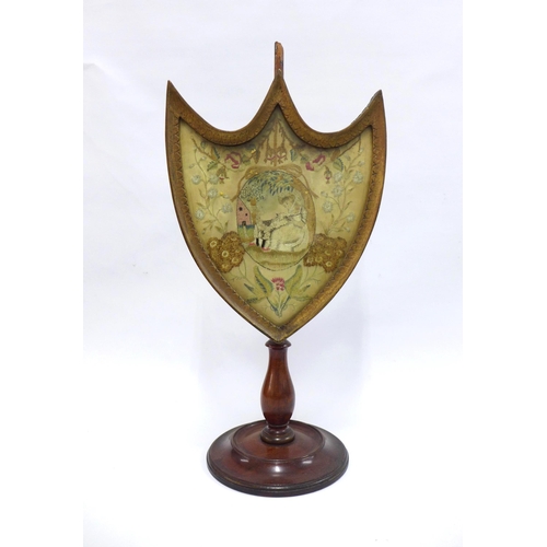 354 - Regency mahogany shield shaped stand with silk needlework panel (top a/f) 25 x 52cm.