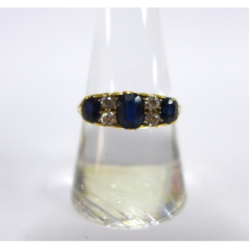 47 - Sapphire and diamond ring claw set with three cushion cut sapphires and four small old round-cut dia... 