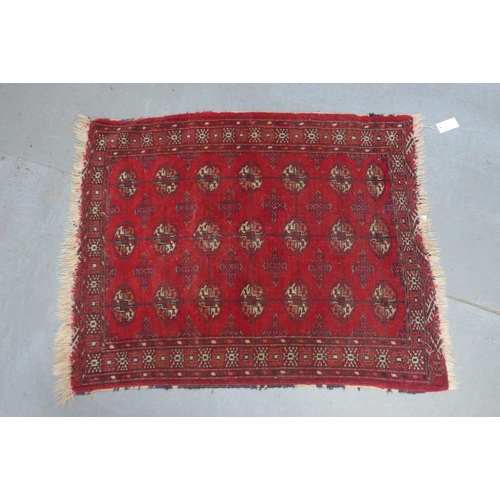 381 - Bokhara rug, red field with three rows of seven guls,  110 x 89cm.