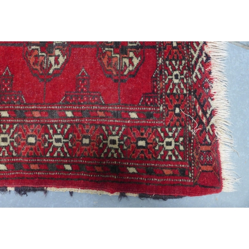 381 - Bokhara rug, red field with three rows of seven guls,  110 x 89cm.