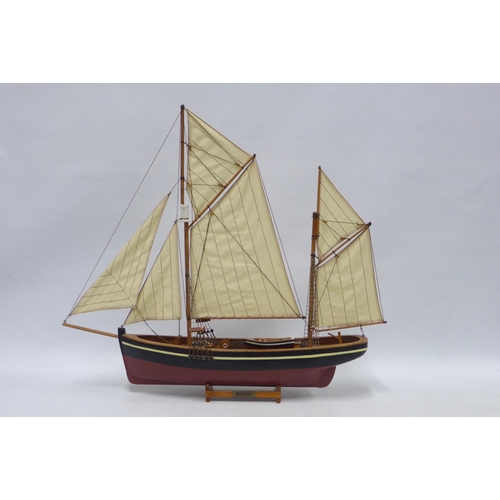 387 - Brixham Trailer model boat on stand, painted hull is approx 50cm long