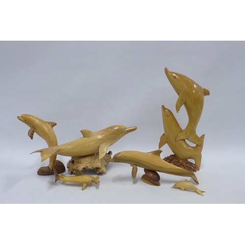 391 - A collection of six wooden dolphins (6)