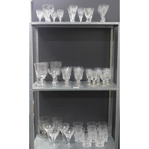 402 - A suite of facet cut stemware and other drinking glasses to include tumblers, rummers and wine glass... 