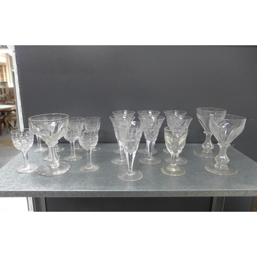 402 - A suite of facet cut stemware and other drinking glasses to include tumblers, rummers and wine glass... 