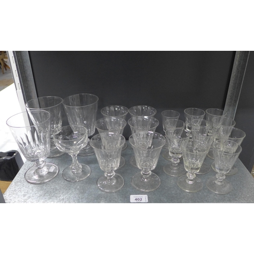 402 - A suite of facet cut stemware and other drinking glasses to include tumblers, rummers and wine glass... 