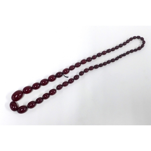 11 - Early 20th century graduating strand of faux cherry amber beads,