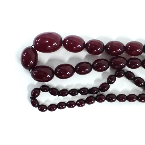 11 - Early 20th century graduating strand of faux cherry amber beads,